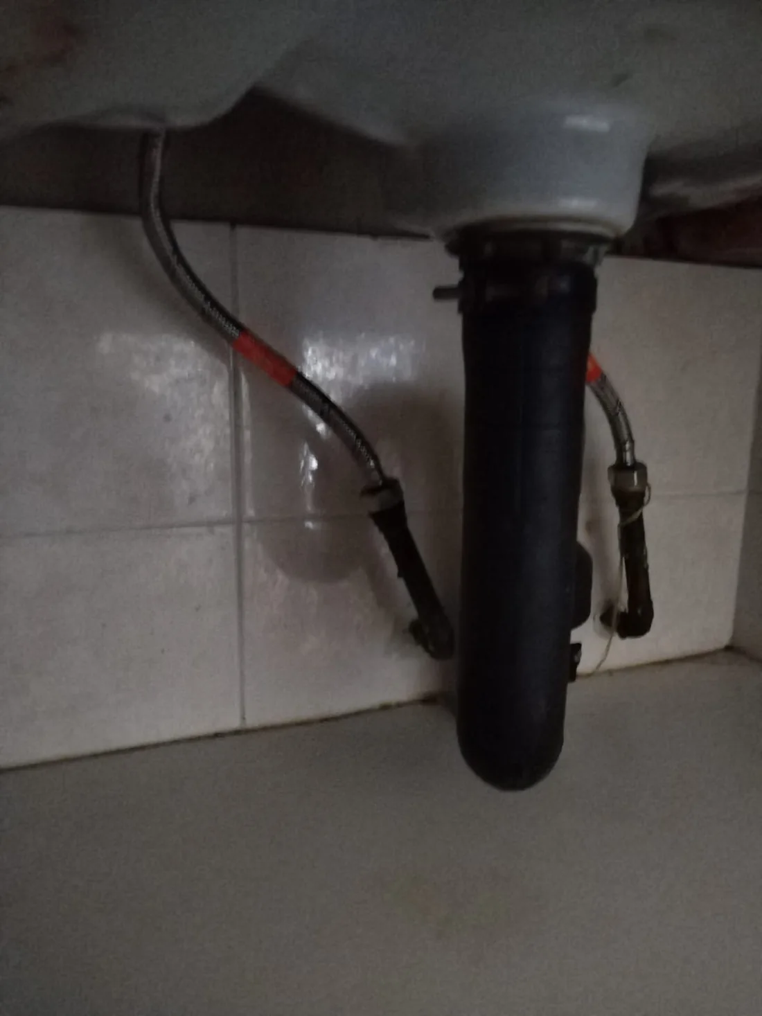 Basin P-trap and waste connections under a sink replaced during a Blairgowrie bathroom repair.