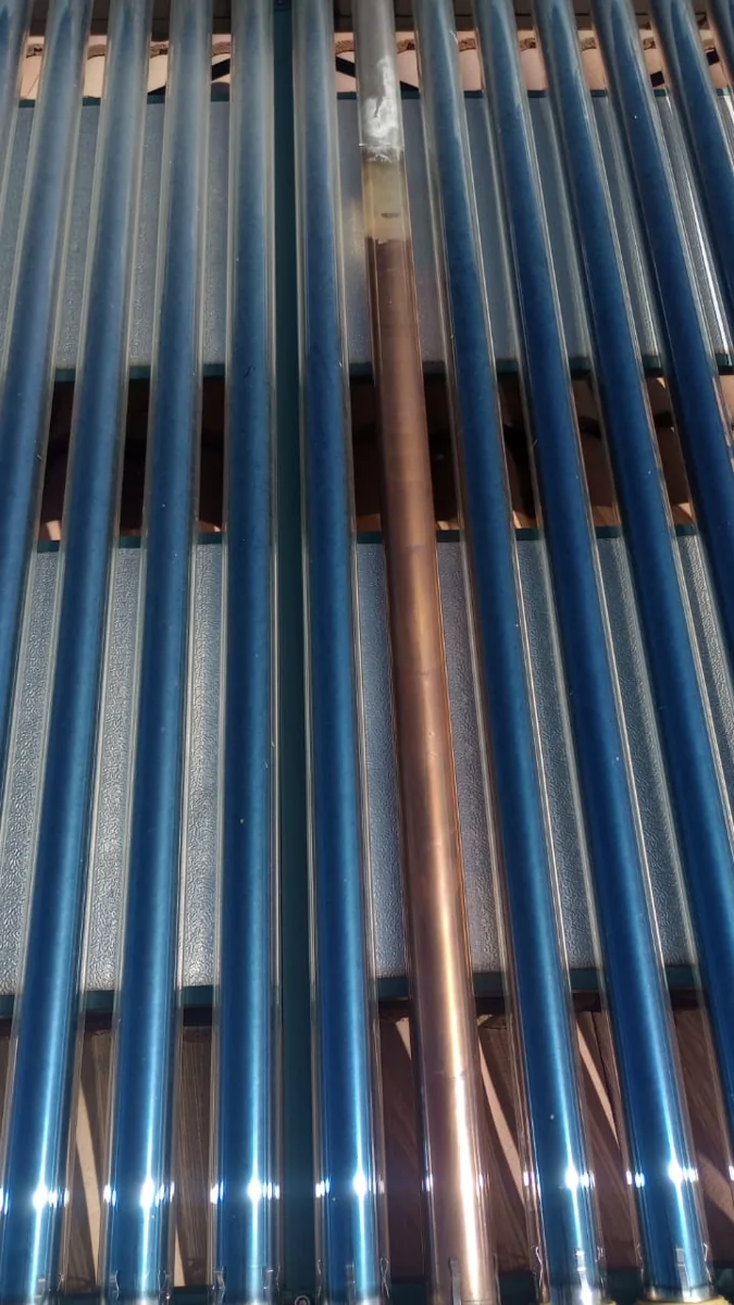 Solar geyser collector repaired with tube work on a roof-mounted solar hot water system in Bordeaux.