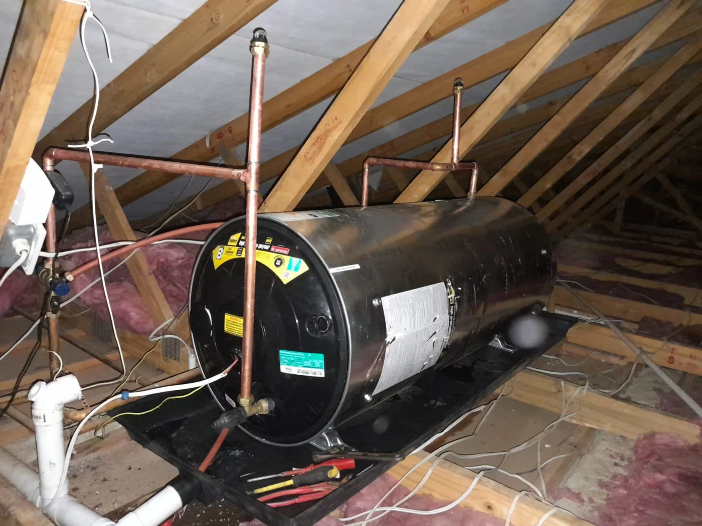 Replacement electric geyser installed in a roof space during a Bromhof plumbing job.