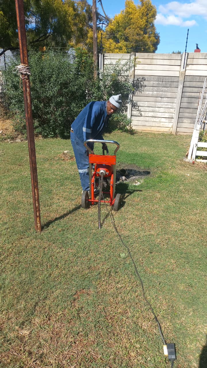 Randburg plumber working with professional plumbing equipment during a local service call.